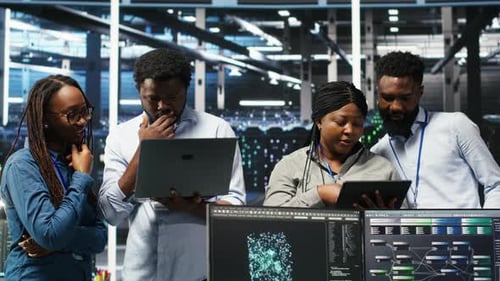 Portrait of Smiling Data Center Specialists Collaborating in Server Facility