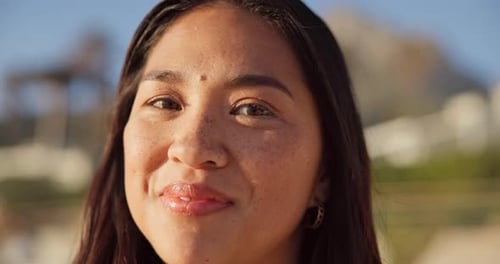 Nature, happy and face of woman at beach for relaxing on holiday, vacation and weekend outdoors