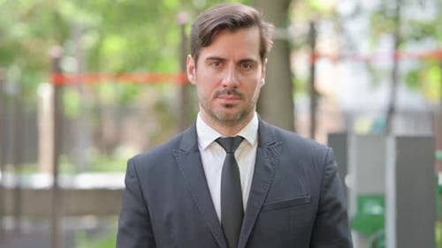 Adult Man In Suit Looking at Camera