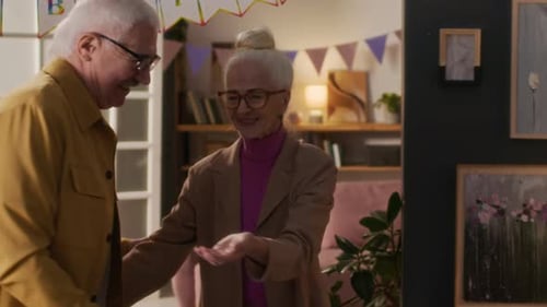 Loving Senior Couple Hugging at Birthday Celebration