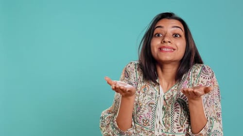 Young Woman Expressing Confusion in Studio on Blue