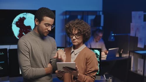 Colleagues Discussing Program on Tablet PC