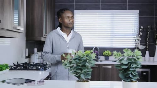 Man drinking coffee in a modern kitchen