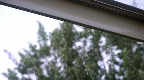 Rain water drops falling tent gutter spilling through, slow mo