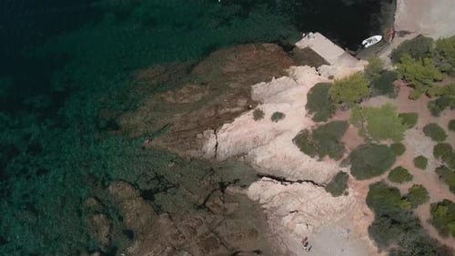 Rocky Shoreline With Vegetation On A Long Sandy Beach During Summer. - Aerial Drone Shot