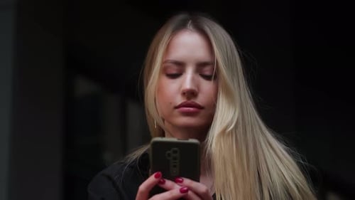 Woman Using Smartphone in Urban Setting