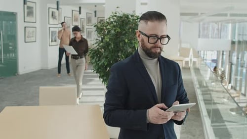 Businessman Using Tablet PC in Office