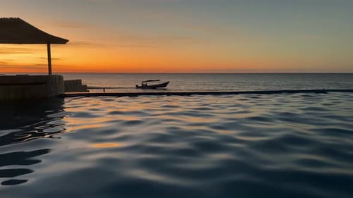 Beautiful sunset over rippling pool and ocean
