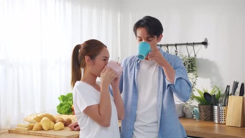 Affectionate Couple Drinks Coffee Together in Kitchen