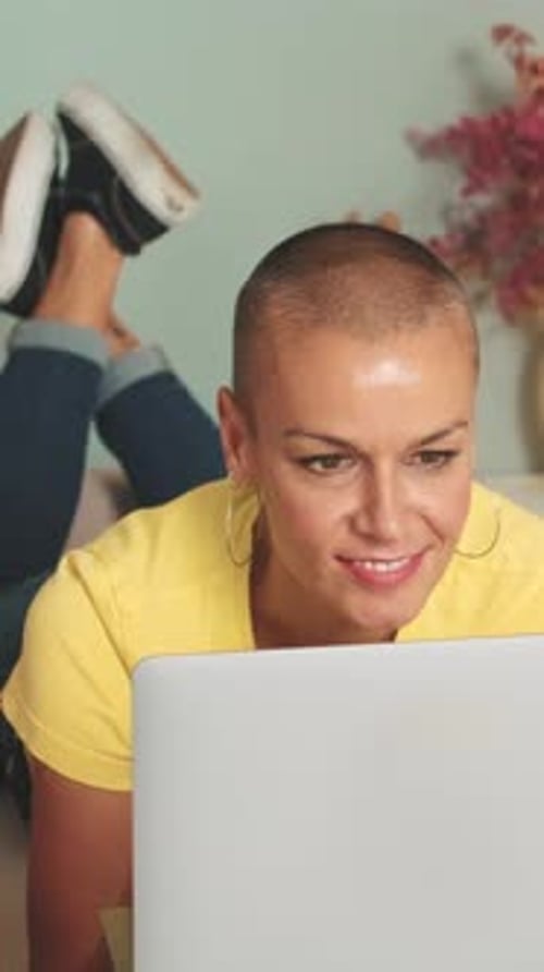 Adult Using Laptop Computer While Lying on Floor