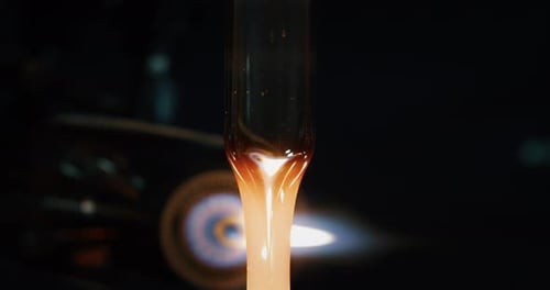 Slow motion macro of glass blowing process by professional worker with hot flame in a workshop. Sh