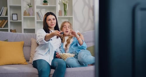 Woman and Child Watching TV Together