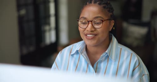 Smiling Woman with Braids Speaking Indoors