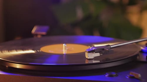 Turntable Spinning Vinyl Record with Blue and Gold Light