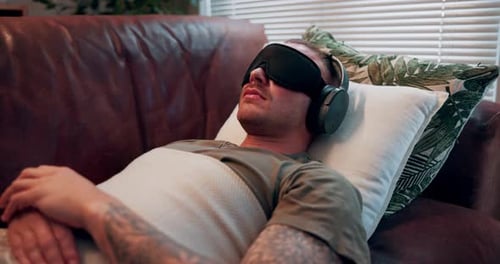 Psychedelic therapy, psychology and man with headphones and eye mask for depression