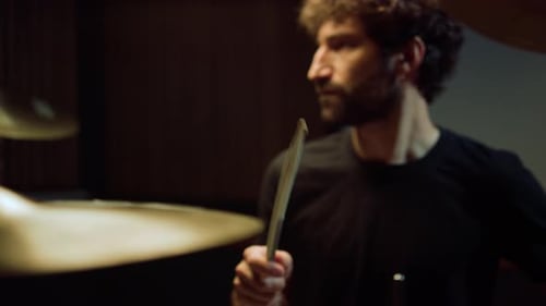 Handsome Artist Playing Rock Music In Recording Studio. Rock Musician Rehearsing With Drum Kit In...