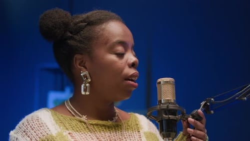 Young Black Woman Speaking in Microphone while Recording Podcast in Studio