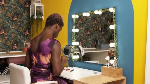 Adult Applying Makeup at Vanity Mirror