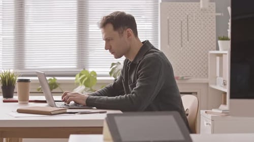 Entrepreneur Working on Laptop Computer in Office