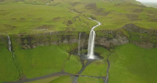 Aerial view of Large waterfall with green landscape in Iceland