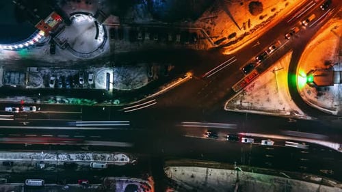 Aerial Top Down View Night Timelapse of Small Crossroad with Circular Cars in Small European City