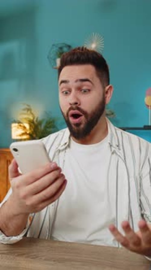 Man Reacts with Surprise to News on Phone