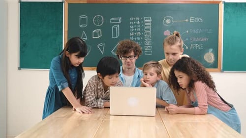 Enthusiastic Children Learning with Teacher on Laptop