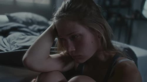 Sad Woman Sitting Alone in Bedroom