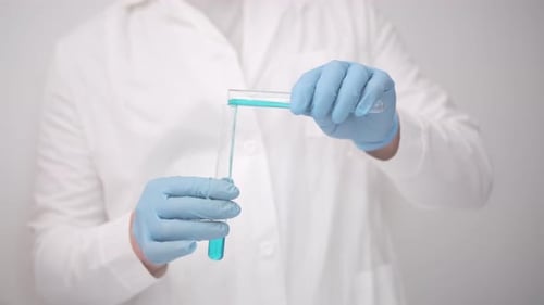 Transferring blue liquid between science laboratory test tubes