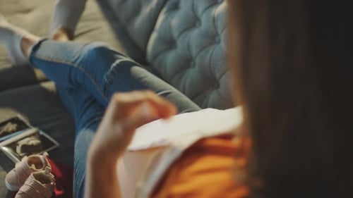 Pregnant Woman Examines Baby Clothes and Ultrasound
