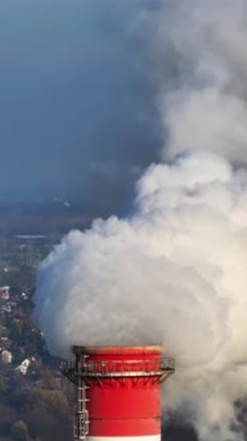 Industrial Chimney Emitting White Smoke in the City