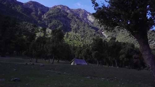 Camping Tent at Mountain Base on Sunny Day