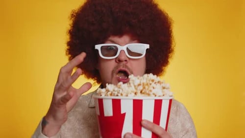 Excited Man Eating Popcorn in 3D Glasses