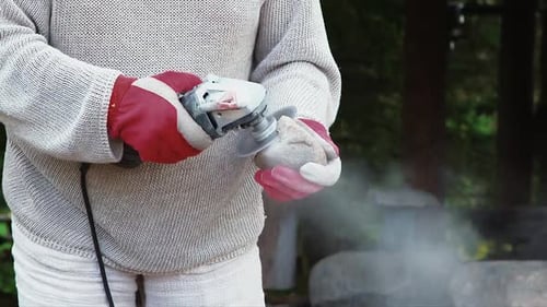 Artist cuts stone with a grinder