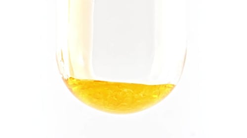 Yellow Liquid in Curved Tube with Air Bubbles