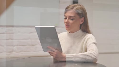 Woman Video Calling on Tablet Indoors During Day