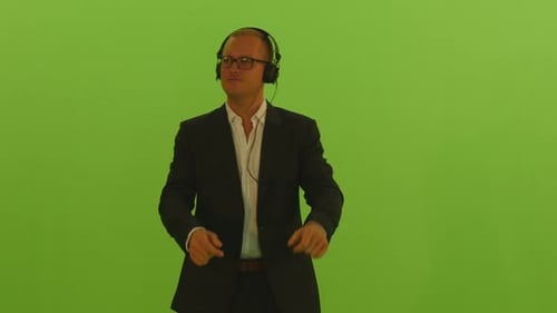 Man Wearing Headphones Listening Music and Dancing on Green Screen