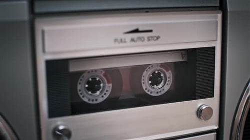 Cassette Tapes Playing in a Vintage Boombox