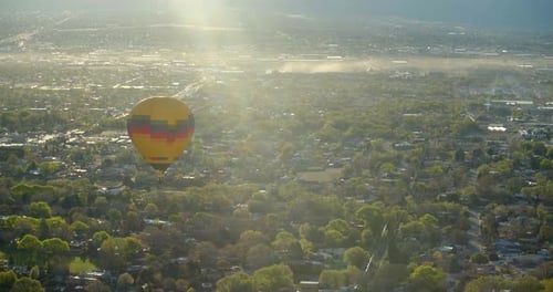 Hot air balloon flying over suburban neighborhood