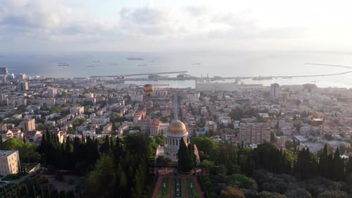 Hot air balloon above Haifa bay and Downtown area at sunrise, Aerial view