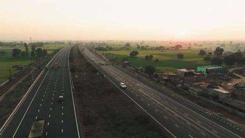 Aerial view of highway cutting through fields, India.