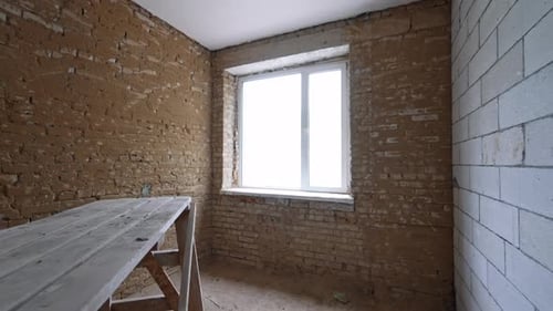 New walls of white bricks are added in the old building.
