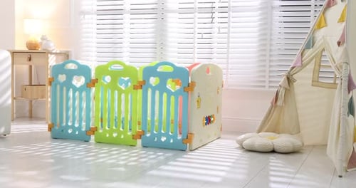 Beautiful playpen, wigwam and sofa in room, camera moving left