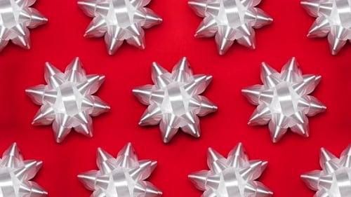 Set of Foil Spinning White Bows Isolated on Red Background Ballet of Present Decoration for Holiday