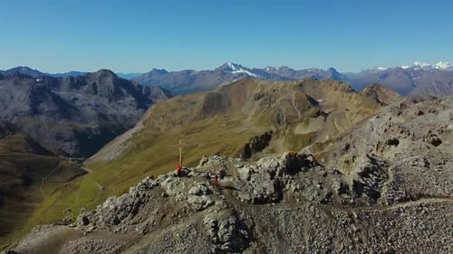 Hikers on Mountain Peak with Expansive Alpine Vista