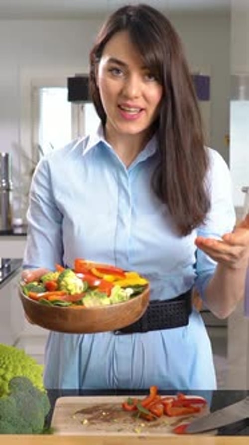 Young Woman Prepares Vegetables in Kitchen