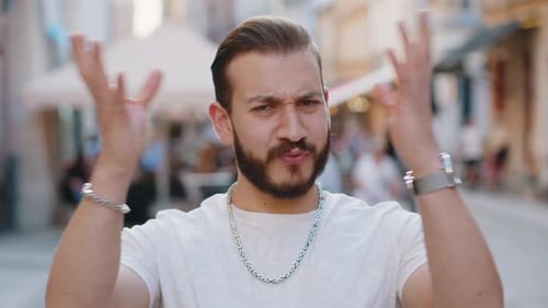 Young Man Looking Surprised at Camera Shocked By Sudden Win Good Victory News Wow in City Street