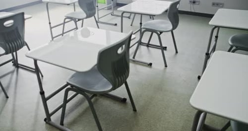 Interior of Modern Empty Primary School Classroom with Working Desks and Chairs for Young Students