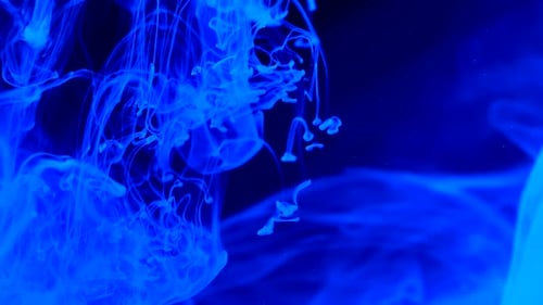 Abstract Blue Ink Swirling in Dark Water