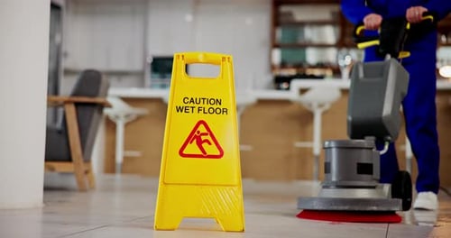 Janitor, person and caution sign with sanitation service, wet floor and disinfection in office